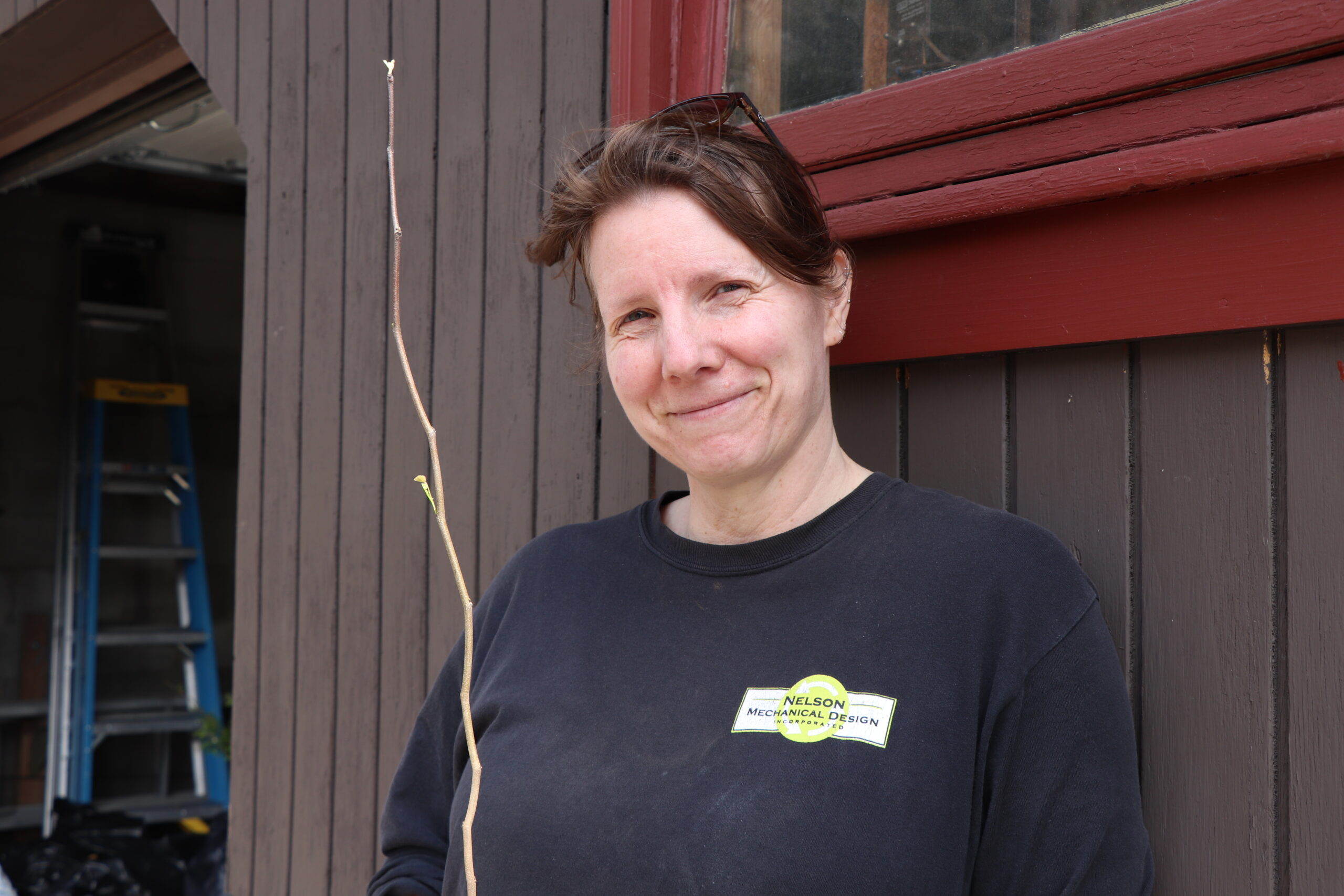Courtney Butler 042525 Courtney Butler with an Eastern redbud
