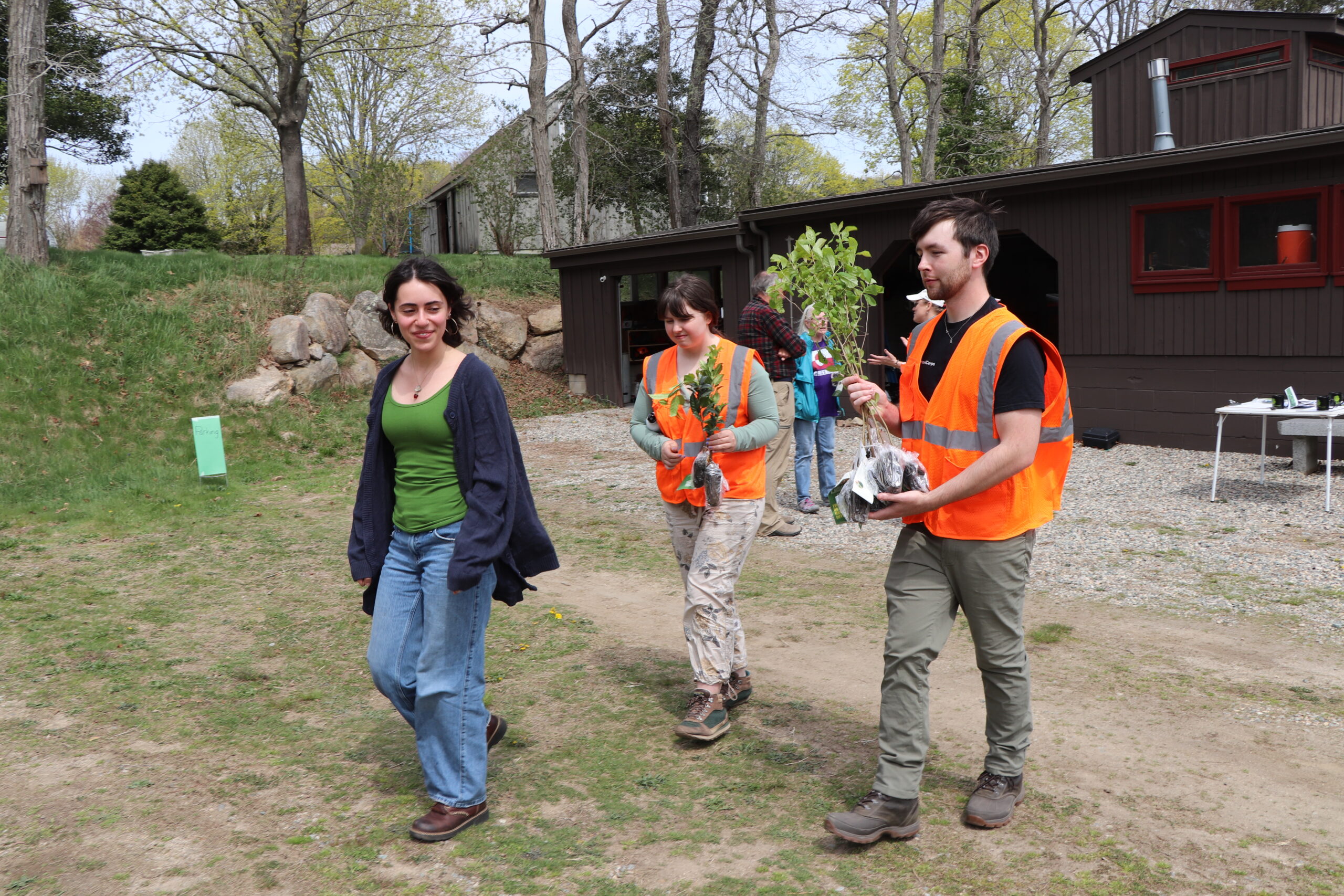 Leeza Barstein, Grace, Liam, 042525 Americorps service members Grace and Liam help carry Leeza Barstein's trees.